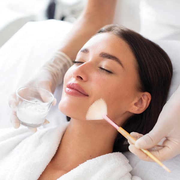 Woman receiving facial treatment at Kiara Lifestyle Clinic in East Delhi.